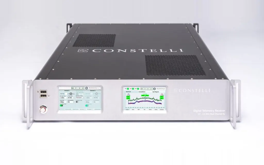 Constelli's rack-mounted digital telemetry receiver, its two front-panel touchscreens showing channel settings and a live signal spectrum